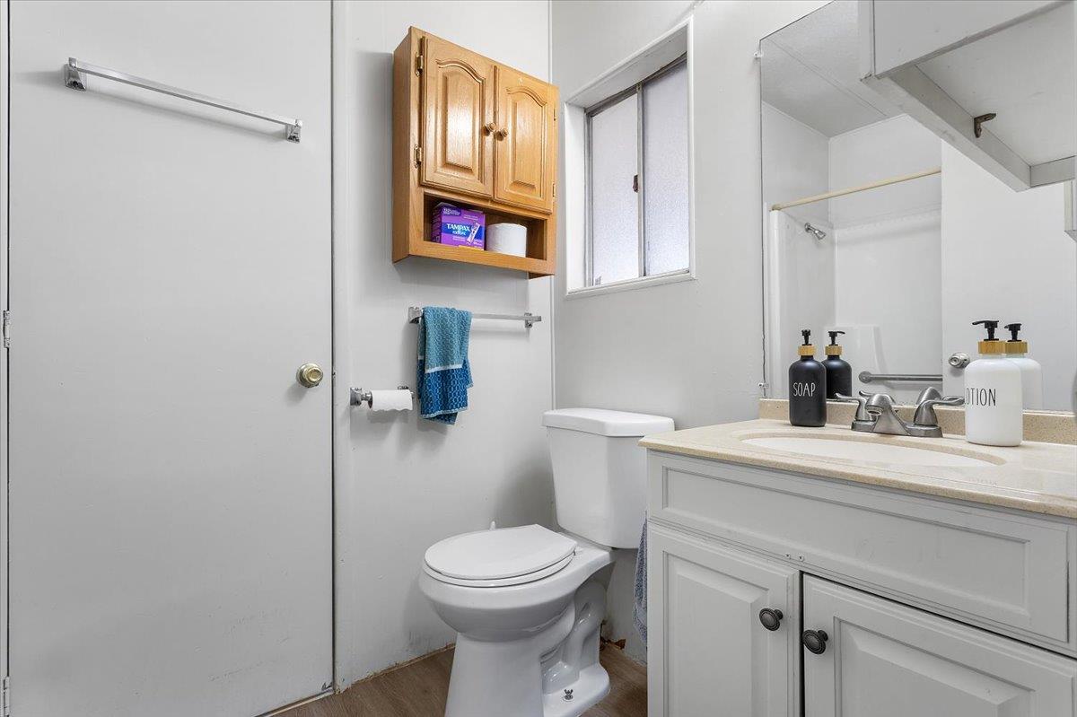 4837 Faith Home Road, Unit 177 Ceres, CA 95307 - Photo 23 of 31 a bathroom with a toilet sink and mirror