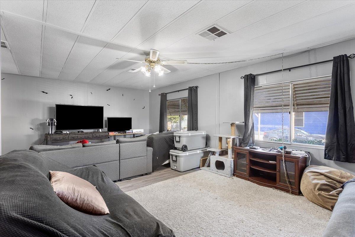 4837 Faith Home Road, Unit 177 Ceres, CA 95307 - Photo 5 of 31 a living room with furniture and a flat screen tv