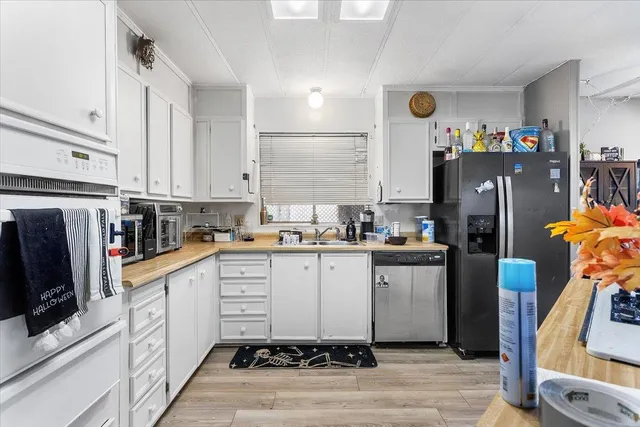 a kitchen with stainless steel appliances a refrigerator sink and microwave