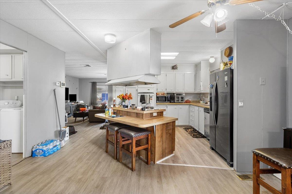 4837 Faith Home Road, Unit 177 Ceres, CA 95307 - Photo 10 of 31 a living room with stainless steel appliances furniture a rug and a kitchen view