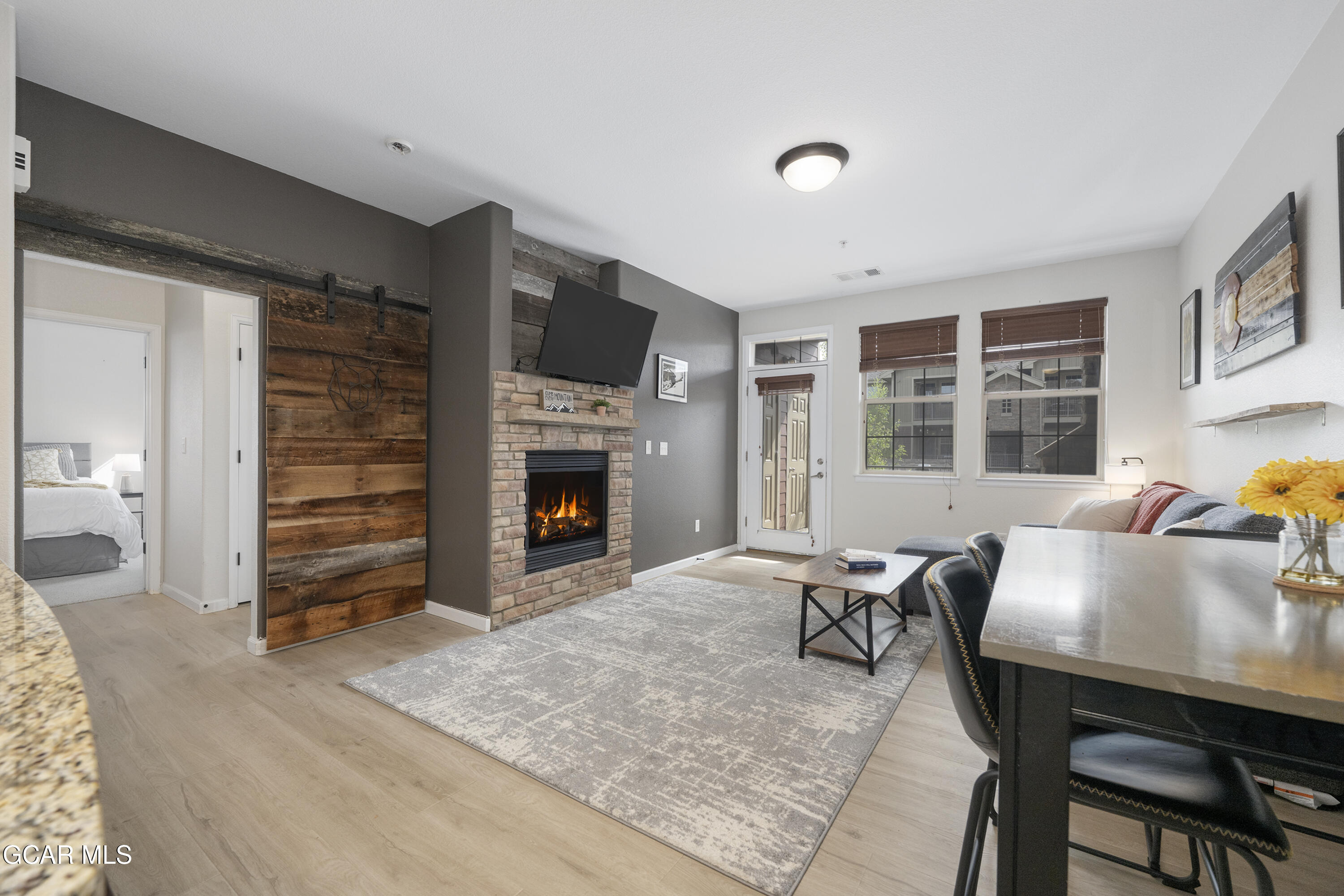 158 Village Road Granby, CO 80446 - Photo 8 of 46 a workspace with furniture hardwood and a kitchen