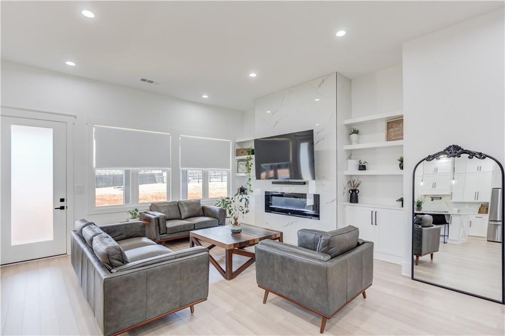 246 Pleasant Hill Church Road Northeast Winder, GA 30680 - Photo 12 of 64 a living room with furniture a fireplace a flat screen tv and kitchen view