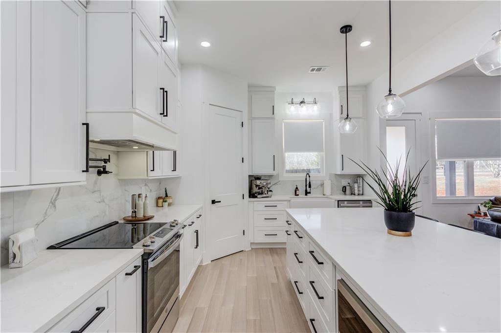 246 Pleasant Hill Church Road Northeast Winder, GA 30680 - Photo 18 of 64 a kitchen with a sink a stove and cabinets