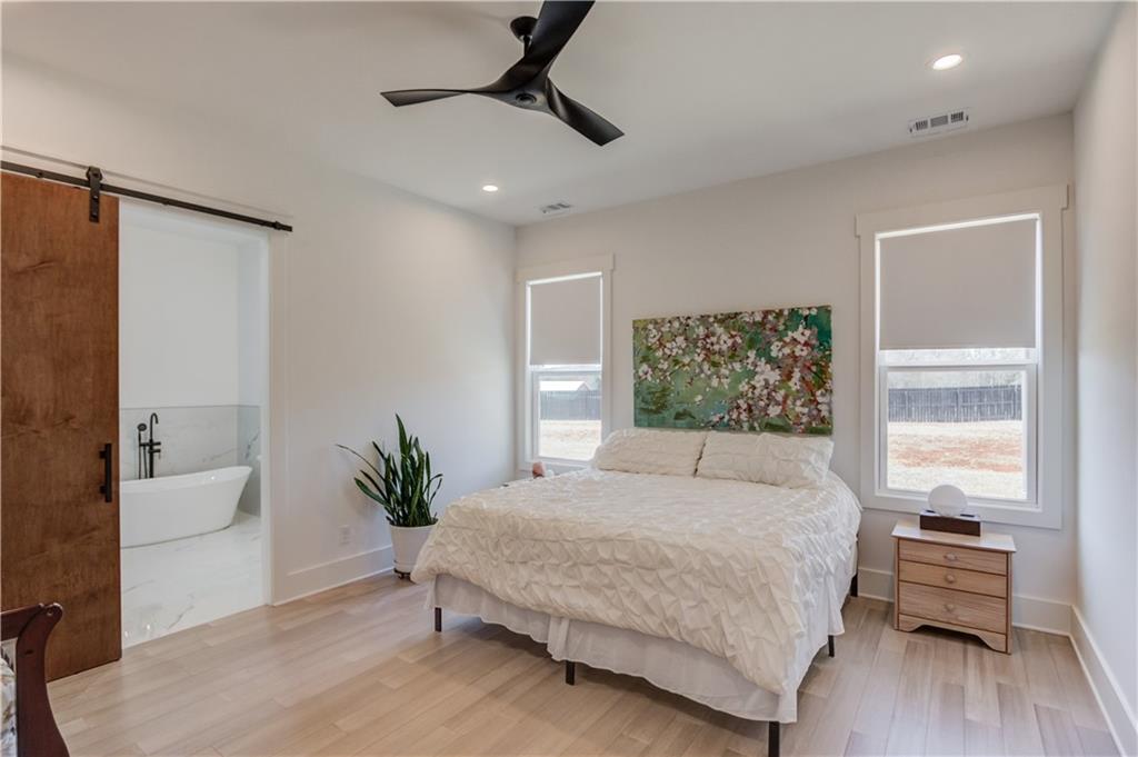 246 Pleasant Hill Church Road Northeast Winder, GA 30680 - Photo 23 of 64 a bedroom with a large bed and a potted plant