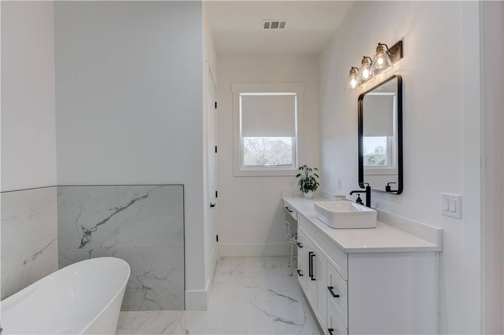 246 Pleasant Hill Church Road Northeast Winder, GA 30680 - Photo 26 of 64 a bathroom with a double vanity sink and a mirror