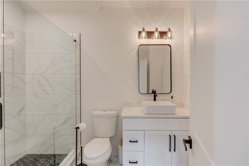 246 Pleasant Hill Church Road Northeast Winder, GA 30680 - Photo 53 of 64 a bathroom with a sink a toilet and mirror