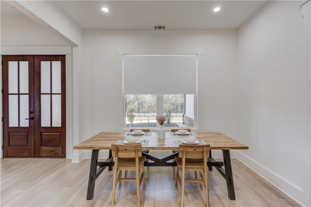 246 Pleasant Hill Church Road Northeast Winder, GA 30680 - Photo 10 of 64 a view of a dining room with furniture and wooden floor