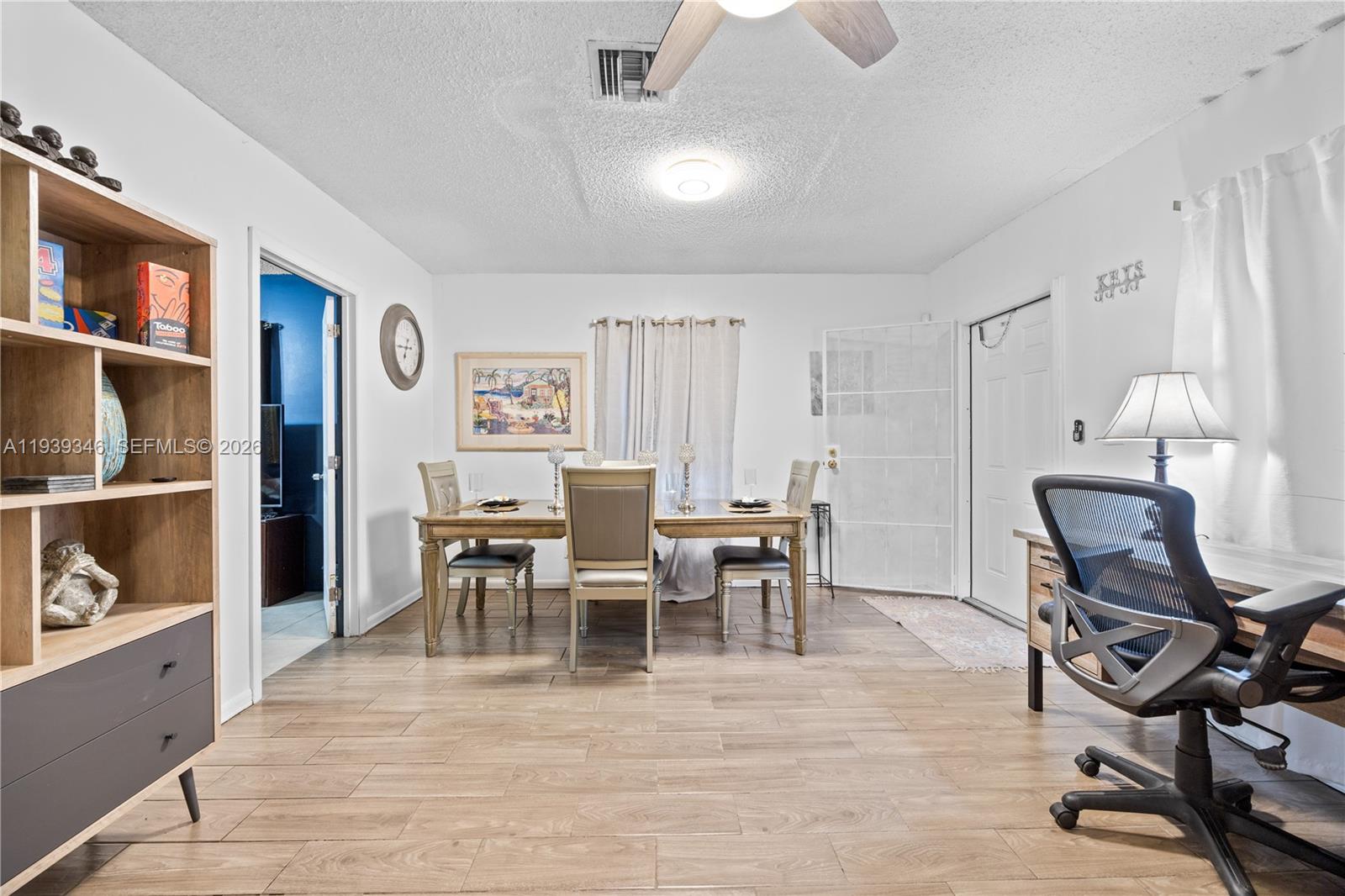 a view of a livingroom with furniture and a workspace