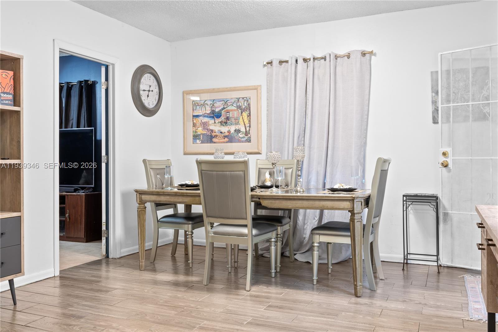 600 Northwest 99th Street, Unit A Miami, FL 33150 - Photo 10 of 23 a view of a dining room with furniture and wooden floor