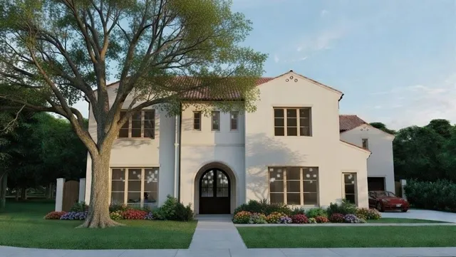 a front view of a house with a garden