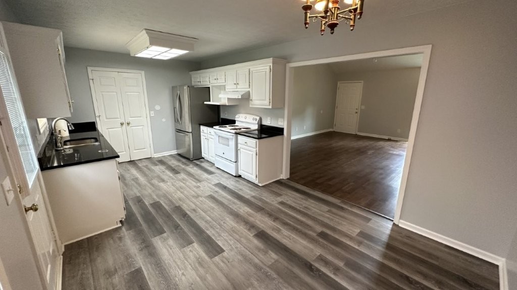 108 Roberts Road Shelbyville, TN 37160 - Photo 3 of 16 a kitchen with a refrigerator and a stove top oven