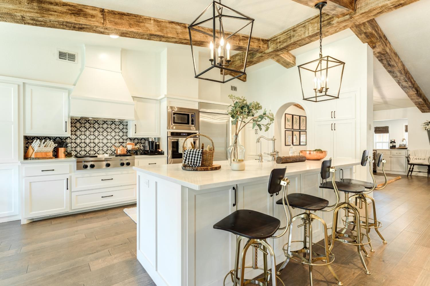 4520 8th Street Lubbock, TX 79416 - Photo 11 of 49 a kitchen with cabinets and chairs