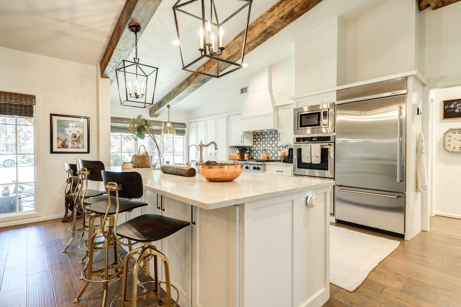 4520 8th Street Lubbock, TX 79416 - Photo 13 of 49 a kitchen with a refrigerator a stove a dining table and chairs with wooden floor