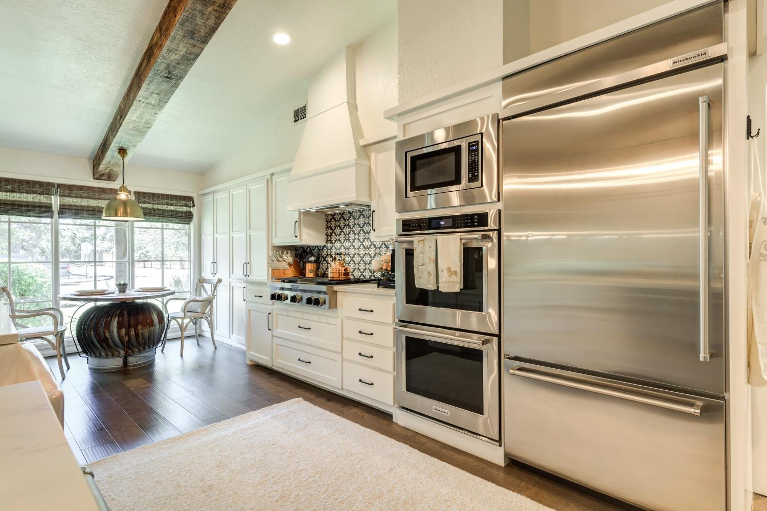 4520 8th Street Lubbock, TX 79416 - Photo 17 of 49 a kitchen with cabinets and stainless steel appliances