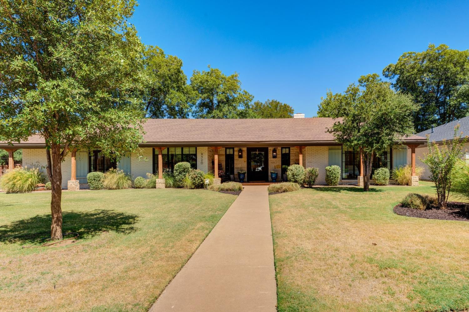 4520 8th Street Lubbock, TX 79416 - Photo 2 of 49 a front view of a house with a yard