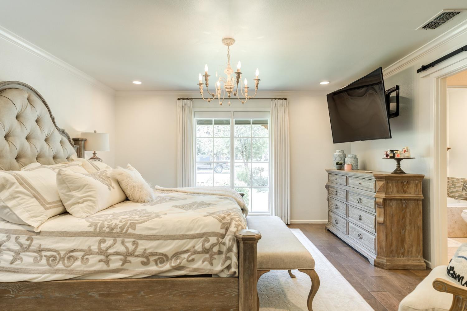 4520 8th Street Lubbock, TX 79416 - Photo 32 of 49 a bedroom with a bed and flat screen tv