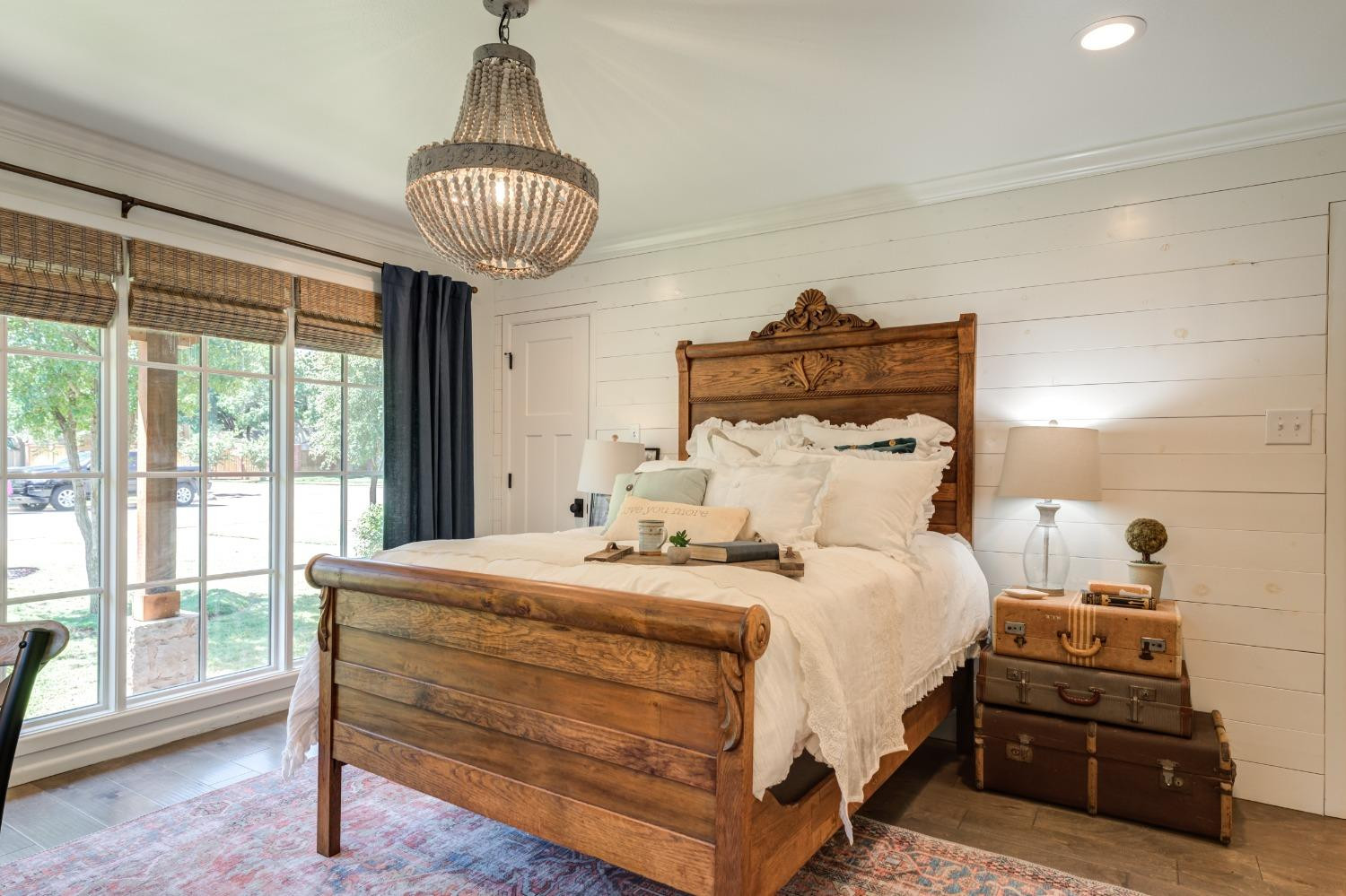 4520 8th Street Lubbock, TX 79416 - Photo 38 of 49 a bedroom with a bed and a chandelier