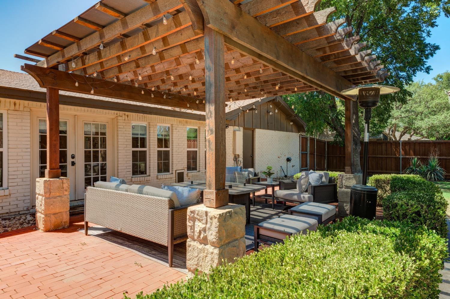 4520 8th Street Lubbock, TX 79416 - Photo 45 of 49 a view of a patio with couches table and chairs and potted plants