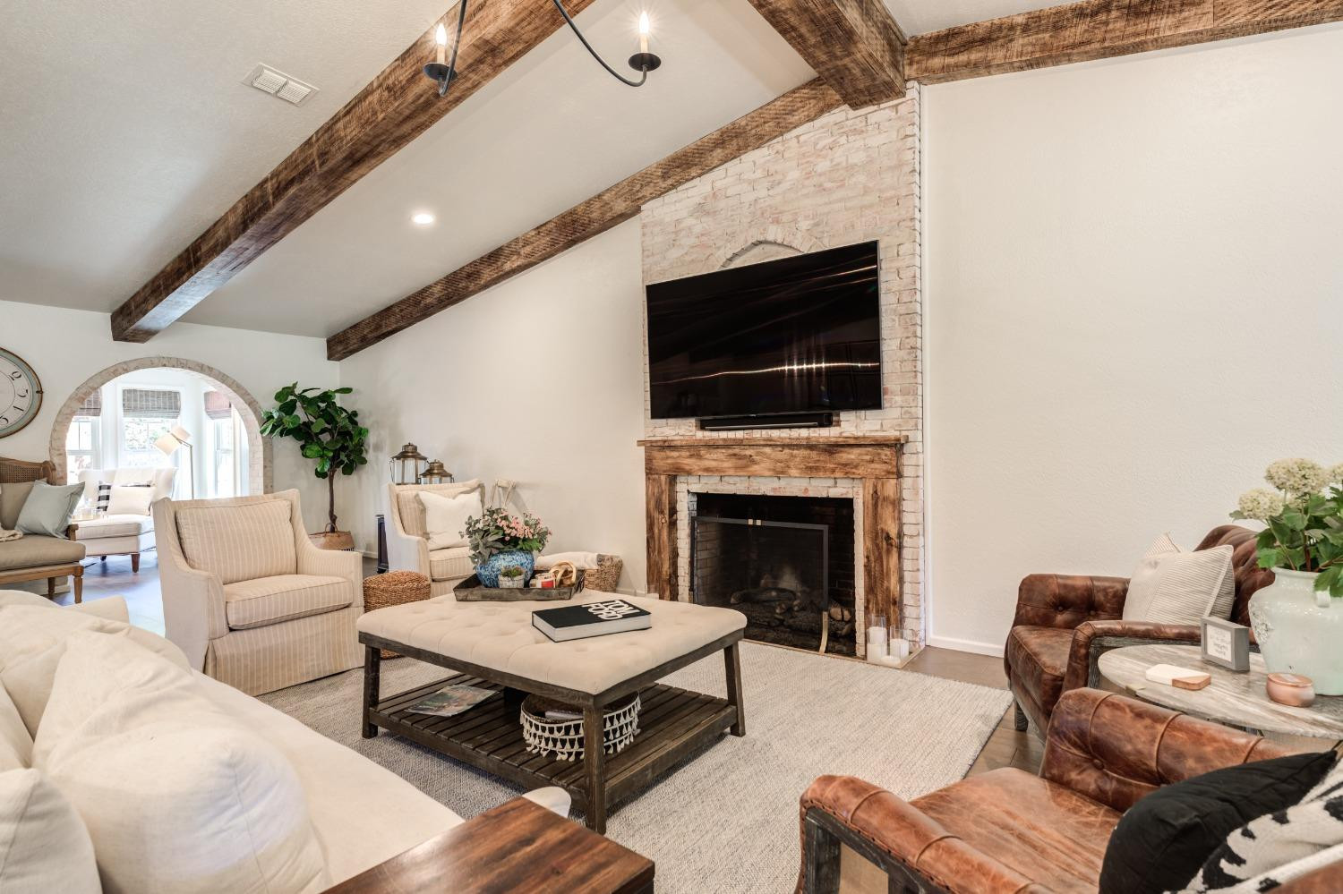 4520 8th Street Lubbock, TX 79416 - Photo 8 of 49 a living room with furniture a fireplace and a flat screen tv