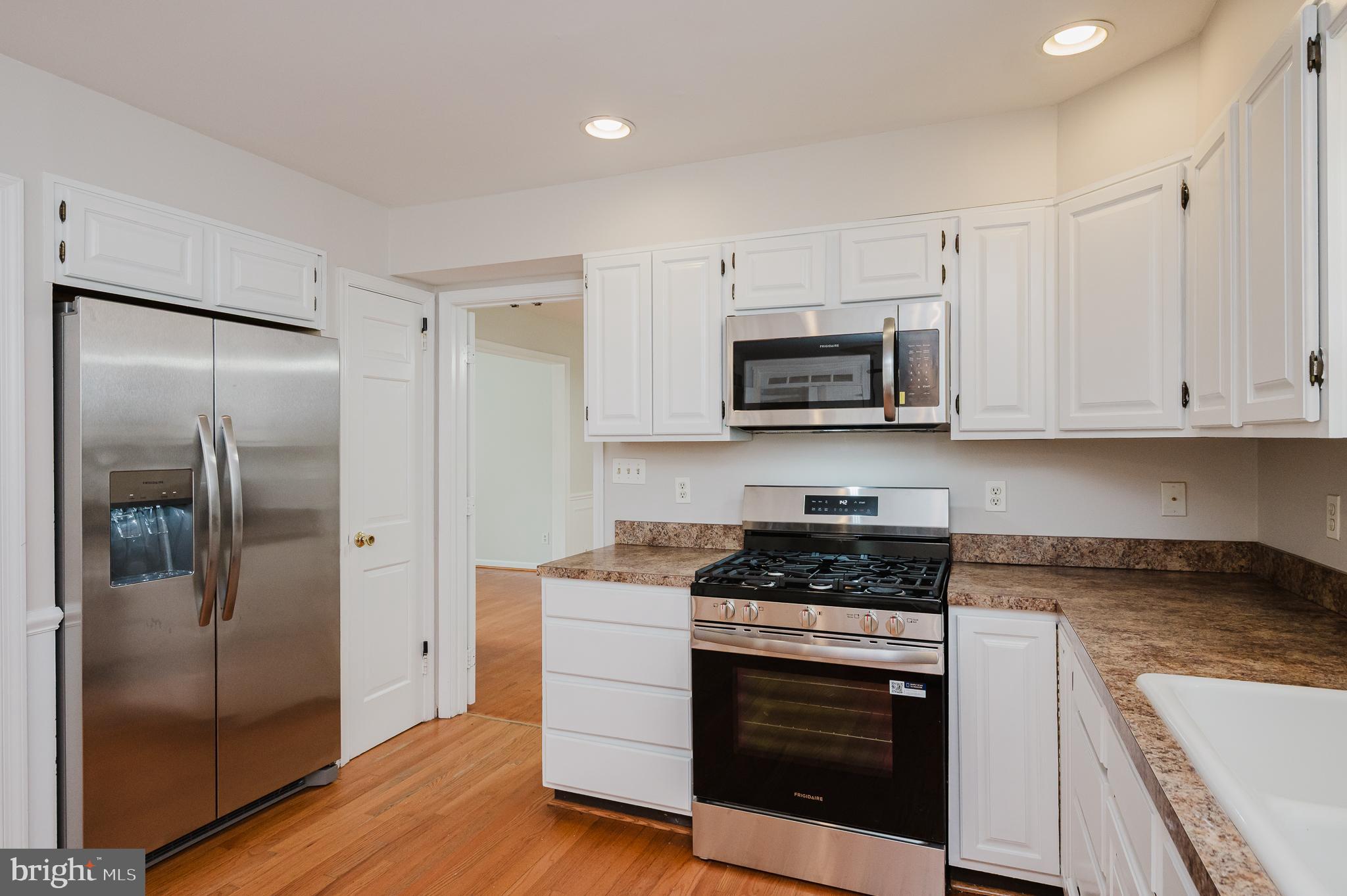 4 Old Spring Court Cockeysville, MD 21030 - Photo 12 of 53 a kitchen with white cabinets and stainless steel appliances