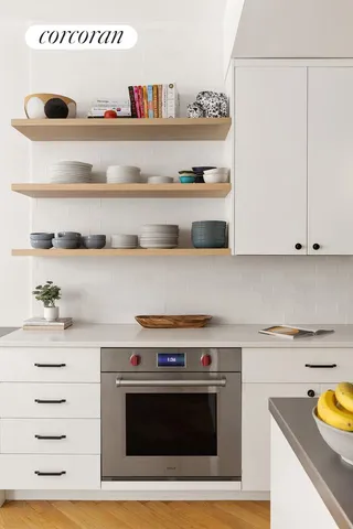 a view of a kitchen with cabinets and appliances