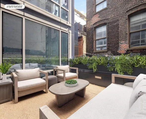 a view of a patio with couches and a table and chairs
