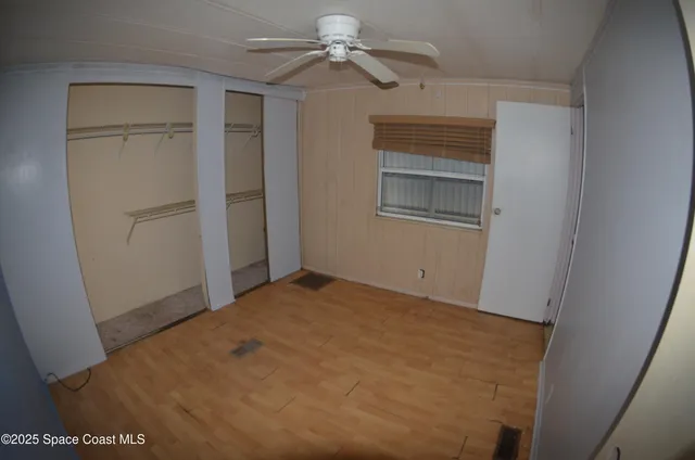 a view of empty room with ceiling fan