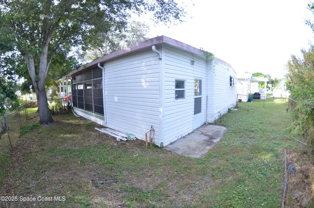 a view of backyard of house with green space