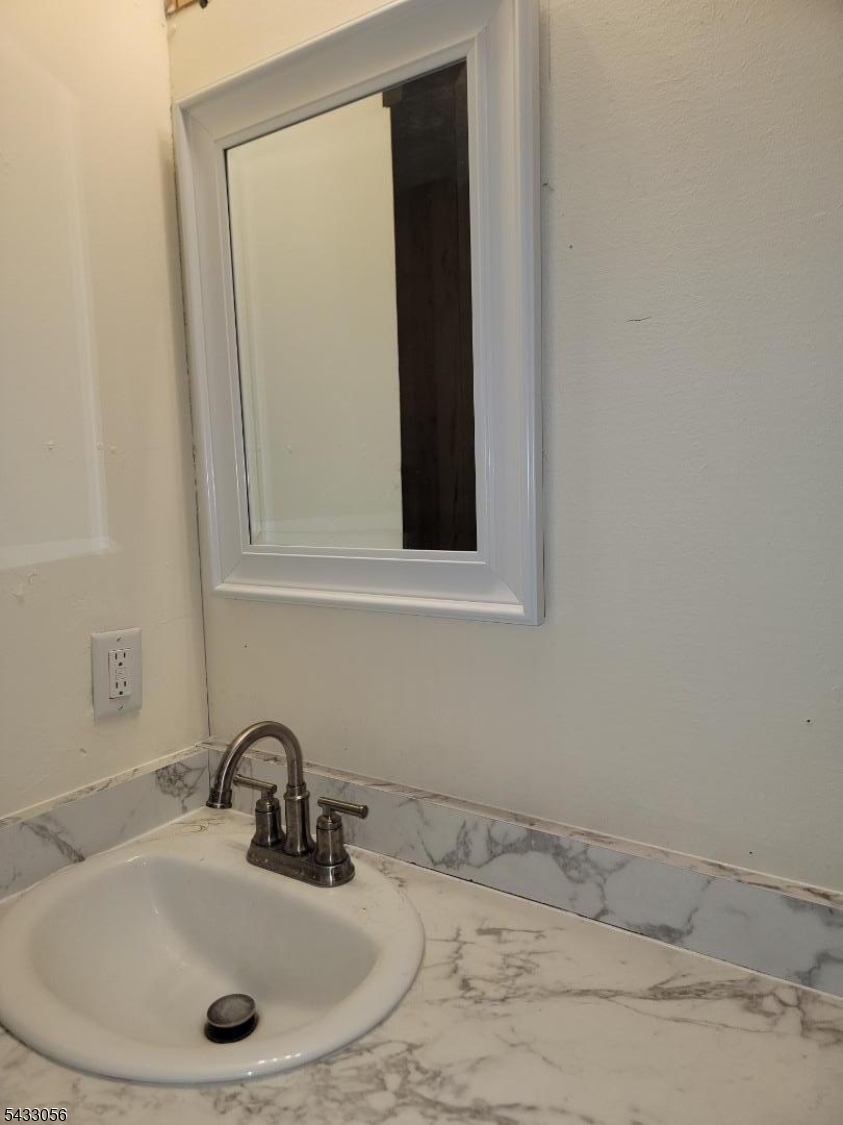 201 Old Chimney Ridge Road, Unit H Montague, NJ 07827 - Photo 4 of 5 a bathroom with a sink and a mirror