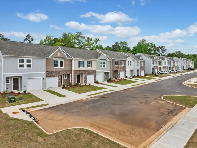 a view of a house with cars park in front of it