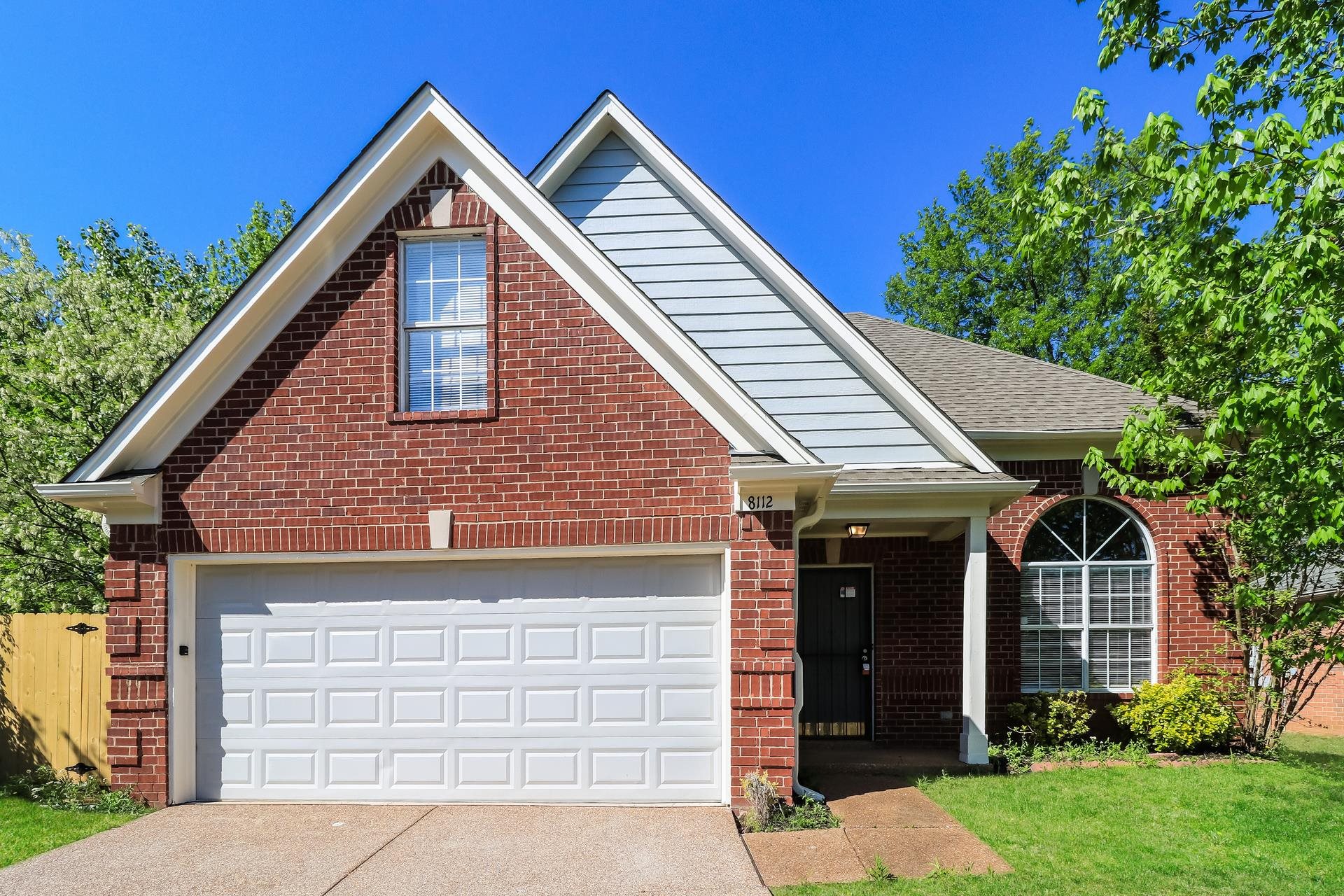 8112 Country Mill Cove Memphis, TN 38016 - Photo 1 of 17 a front view of a house with garden
