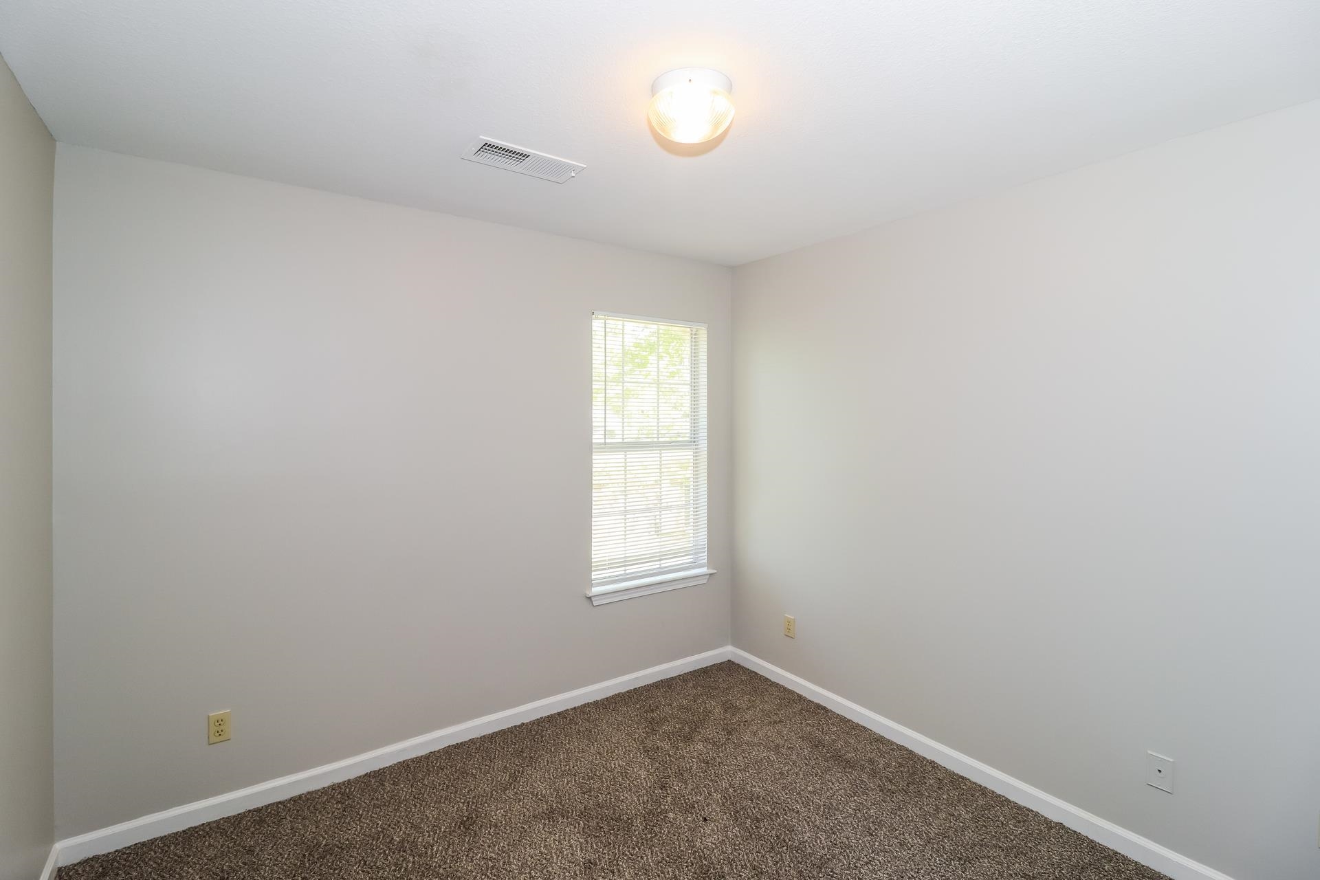 8112 Country Mill Cove Memphis, TN 38016 - Photo 12 of 17 an empty room with windows and closet