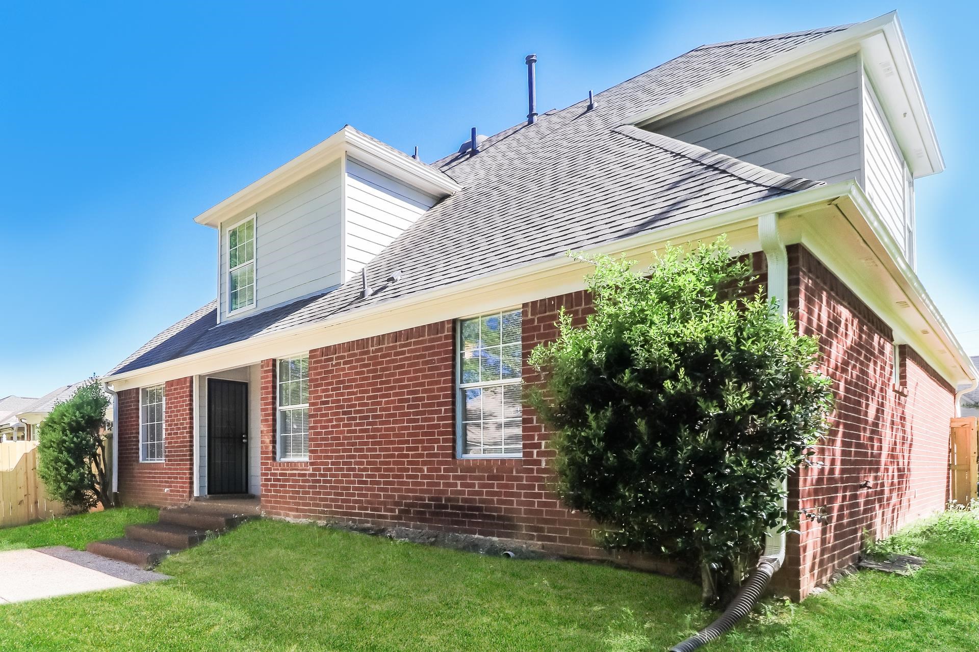 8112 Country Mill Cove Memphis, TN 38016 - Photo 15 of 17 a view of a house with brick walls and a yard with plants