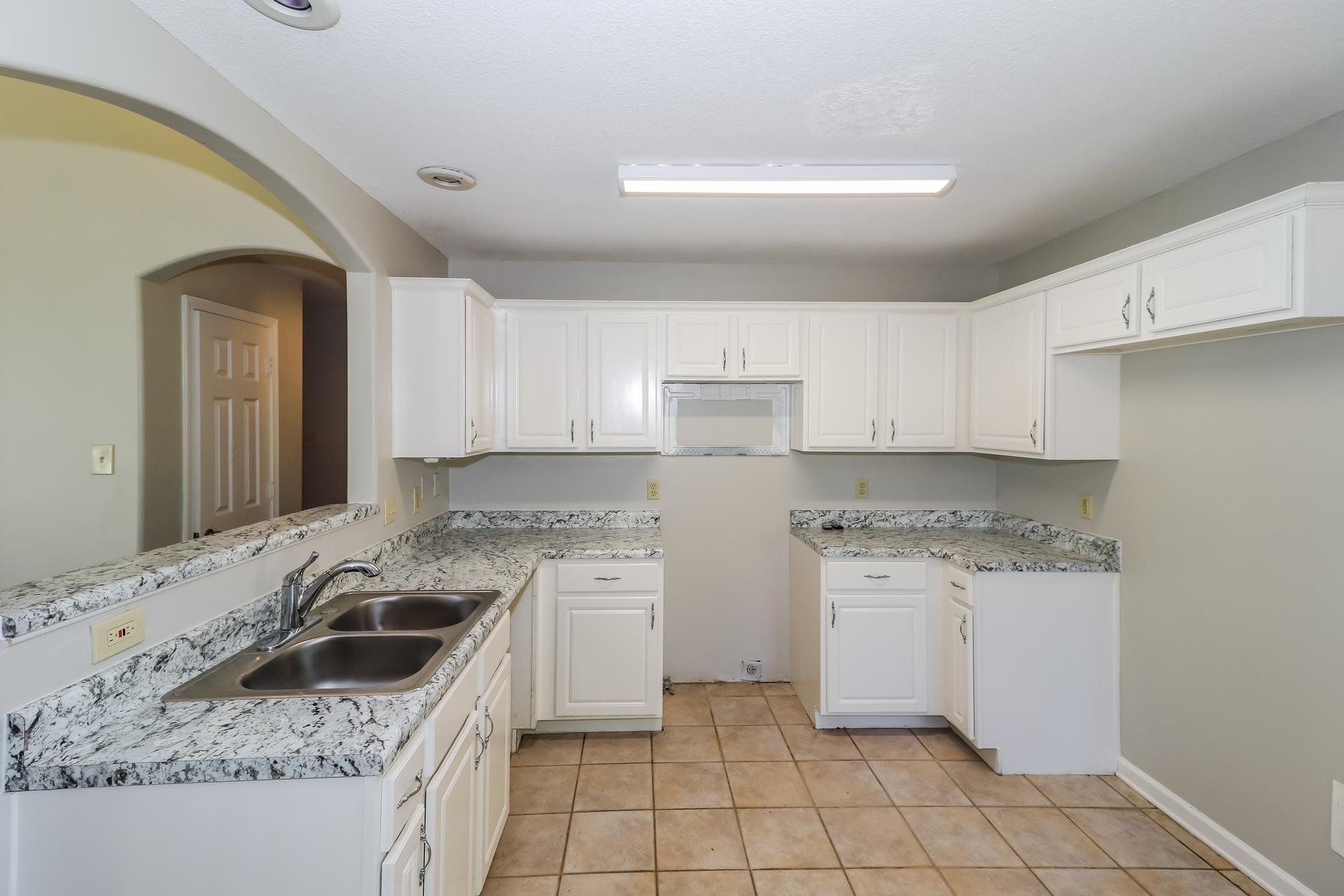 8112 Country Mill Cove Memphis, TN 38016 - Photo 6 of 17 a kitchen with a stove a sink a refrigerator and cabinets