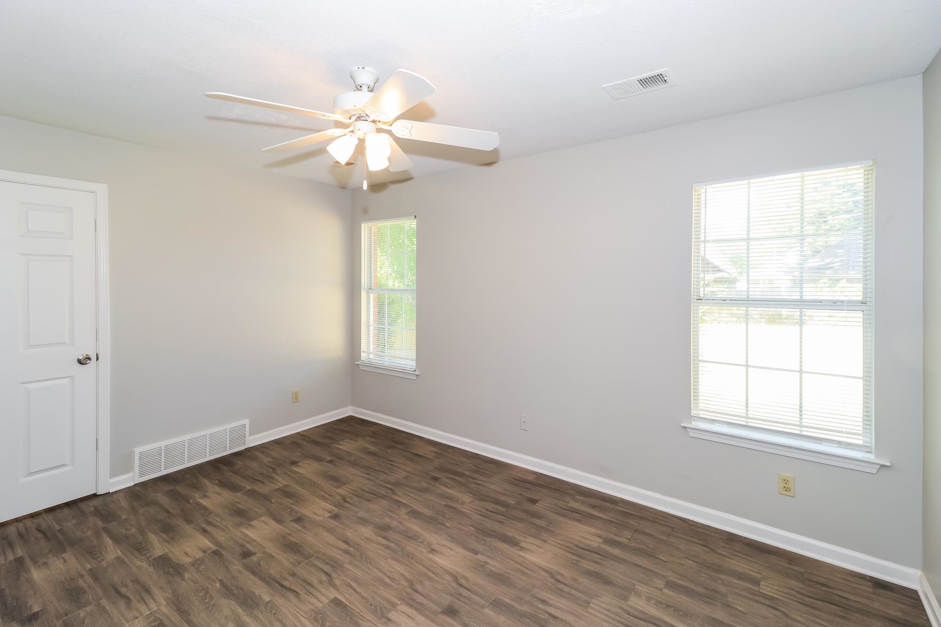 8112 Country Mill Cove Memphis, TN 38016 - Photo 8 of 17 wooden floor in an empty room with a window