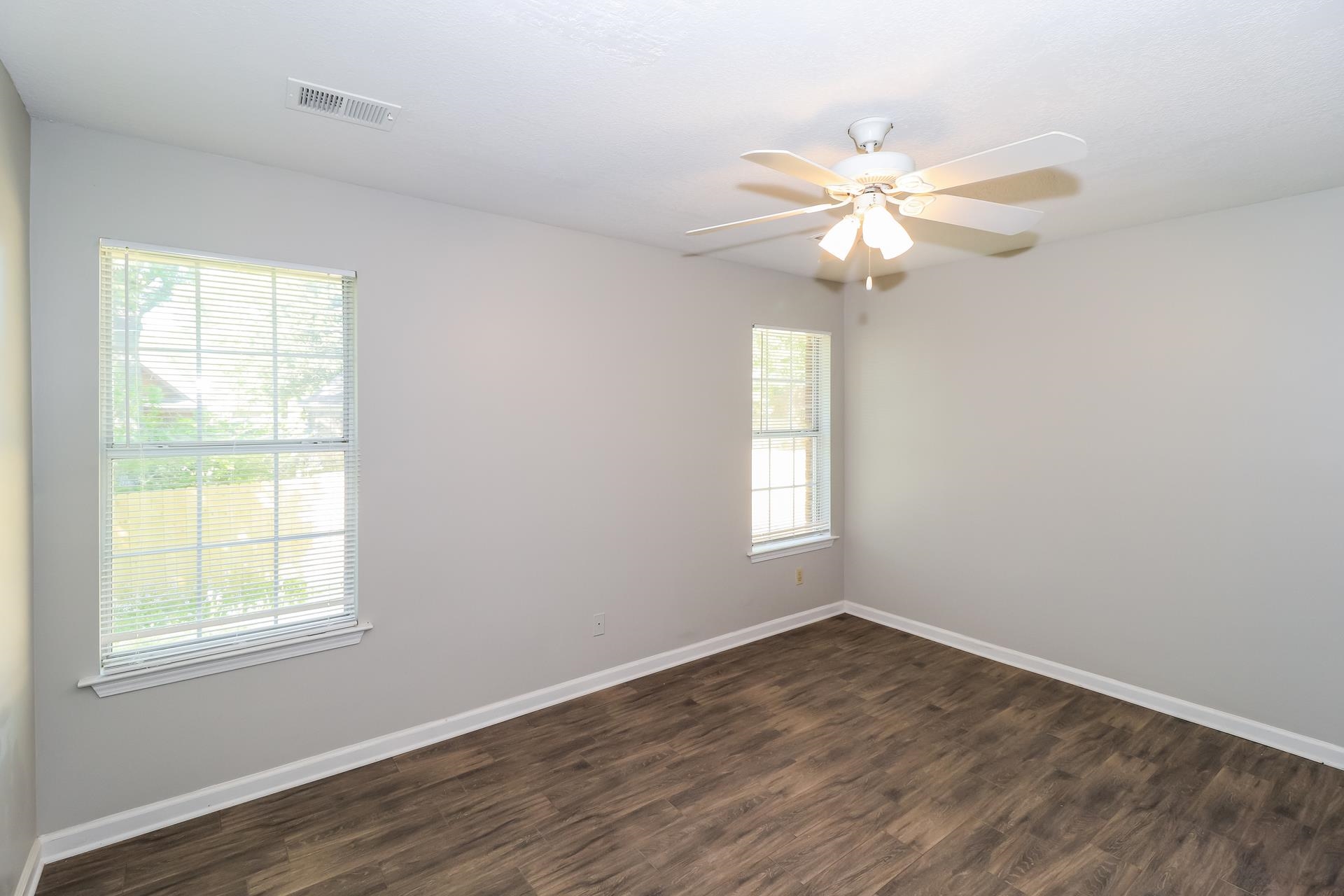 8112 Country Mill Cove Memphis, TN 38016 - Photo 9 of 17 a view of an empty room with wooden floor and a window