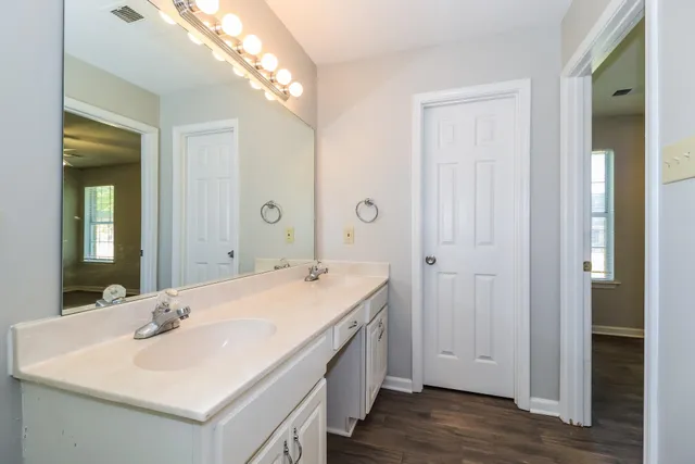 a en suite bathroom with a sink and a mirror