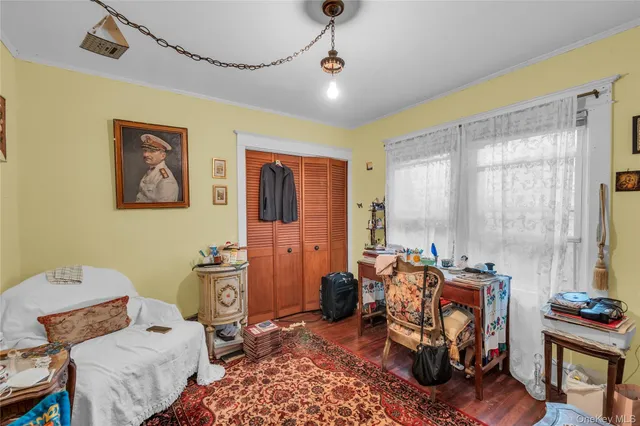 a bedroom with furniture and a window