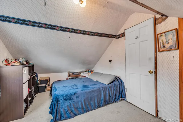 a bed room with a bed and a window