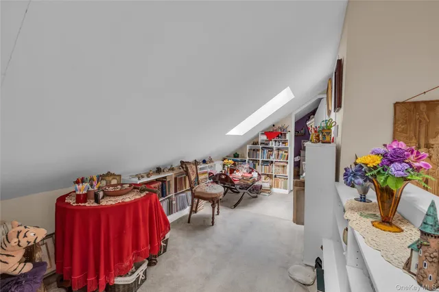 a living room with furniture a couch and a potted plant