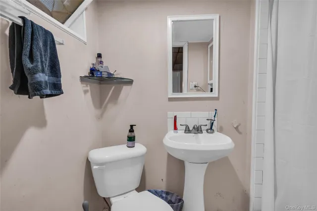 a bedroom with a bed and a television