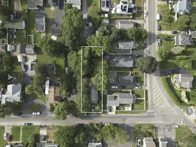 an aerial view of a house with a yard and outdoor seating