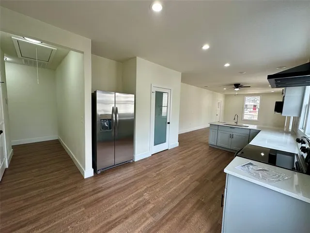 a view of a hallway with wooden floor and front door