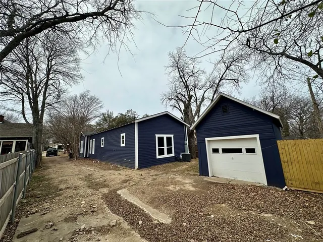 a view of a house with a yard and garage