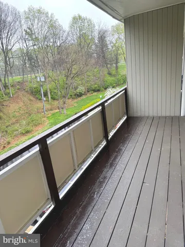 a view of a yard with wooden fence