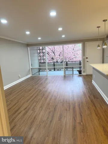 a view of a room with wooden floor
