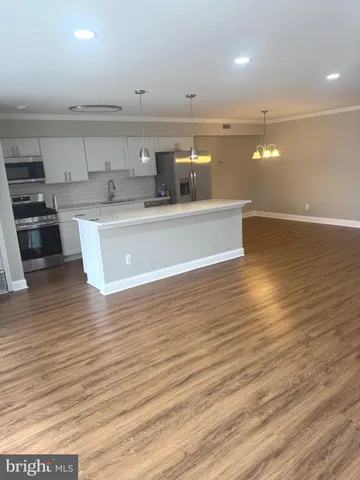 a kitchen with stainless steel appliances granite countertop a sink a stove and a microwave