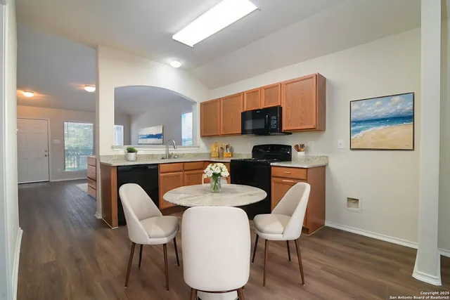 a dining room with furniture and wooden floor