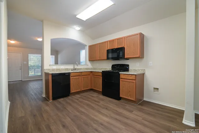 a kitchen with stainless steel appliances granite countertop a stove a sink and a microwave