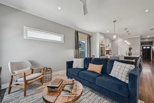 a living room with furniture and a chandelier